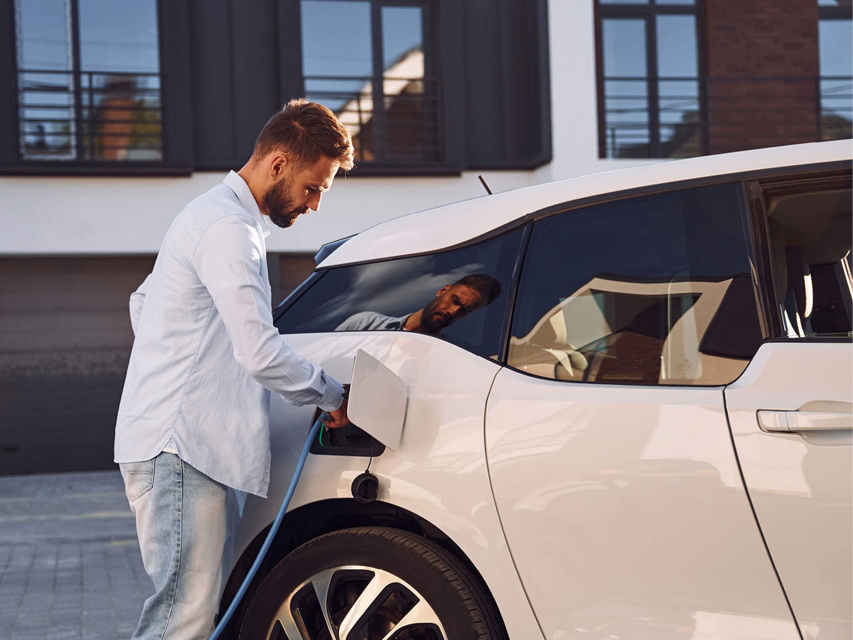 A man charging a car